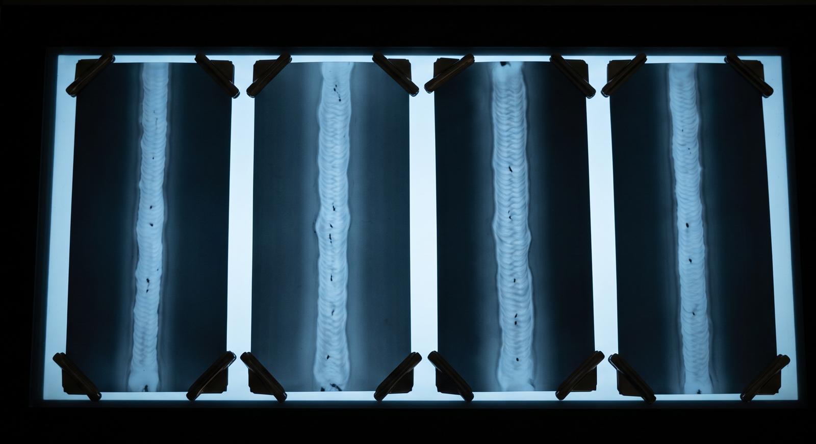 Weld radiograph films clipped to a viewing light box
